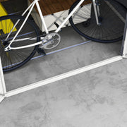 Interior floor view with two bicycles standing on the foundation frame inside the shed