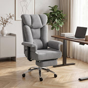 Grey padded office chair in a home office beside a wooden desk and laptop