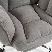 Close-up of the puffy padded seat and armrest in grey fabric