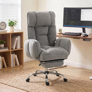 Grey office chair in a home office beside a desk and monitor