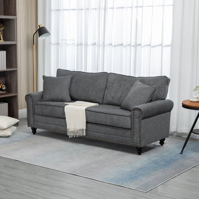 Grey fabric sofa styled in a living room with lamp and throw blanket