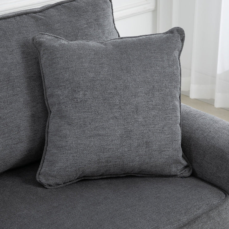Close-up of throw pillow on grey sofa seat cushion