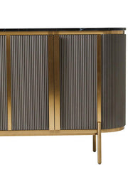 Macro detail of the fluted door panelling and gold trim