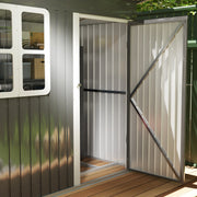 Close-up of the open shed door showing the diagonal brace, the white door frame and the pale interior lining