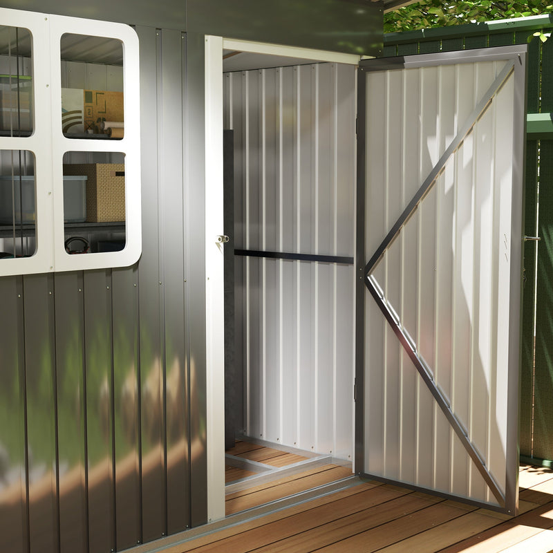 Close-up of the open shed door showing the diagonal brace, the white door frame and the pale interior lining
