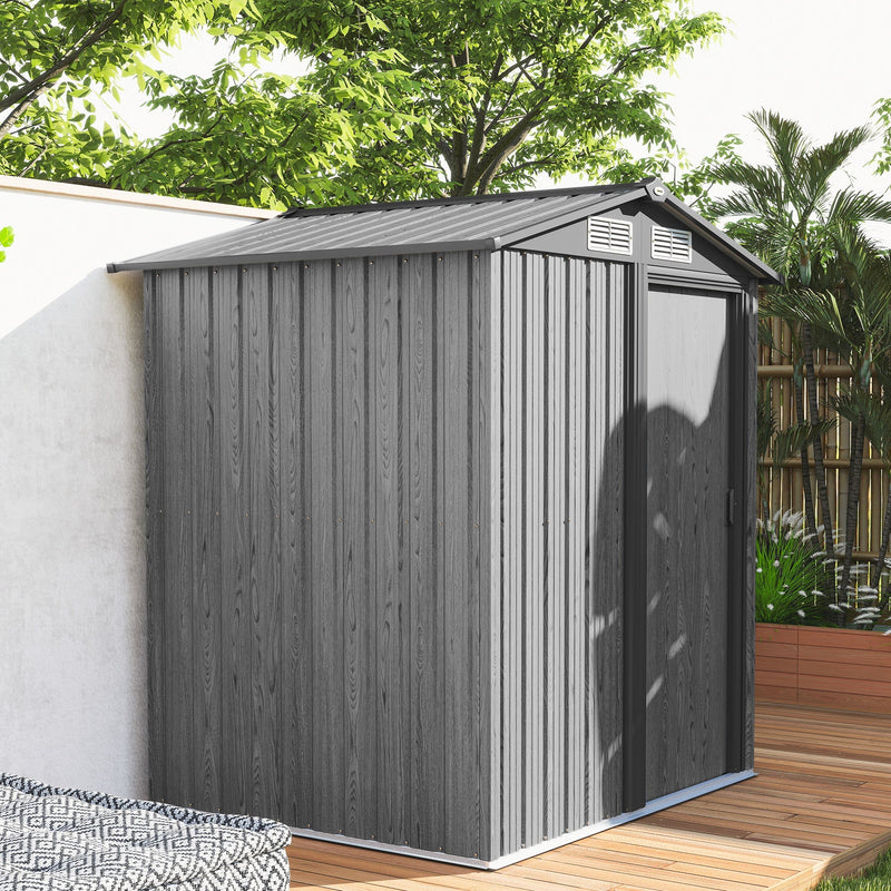 Grey wood effect metal shed on a decked patio beside a white garden wall