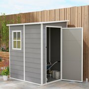 Grey plastic shed against a timber fence with the door open showing buckets and a hose inside