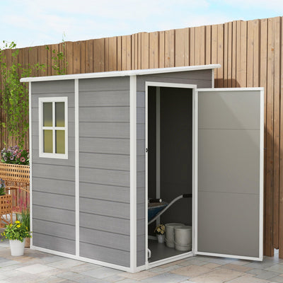 Grey plastic shed against a timber fence with the door open showing buckets and a hose inside