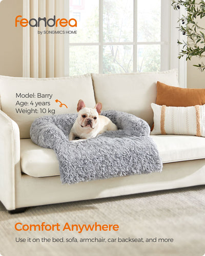 Dog resting inside the sofa bed with head against the raised side