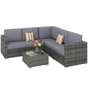 Grey rattan corner sofa set with striped scatter cushions and glass coffee table from the right side