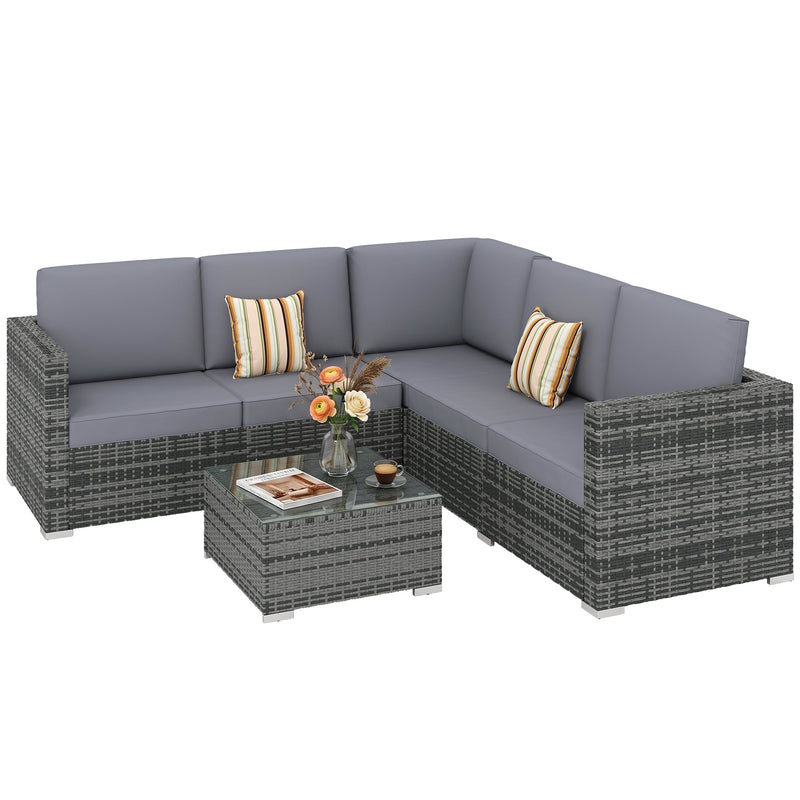 Grey rattan corner sofa set with striped scatter cushions and glass coffee table from the right side