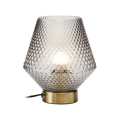 Grey smoked glass table lamp front view on a plain background