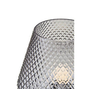 Close-up of embossed texture on grey smoked glass lamp body