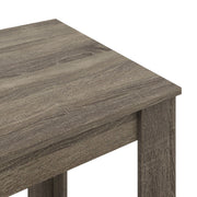 Close-up of the table corner showing the grey wood grain
