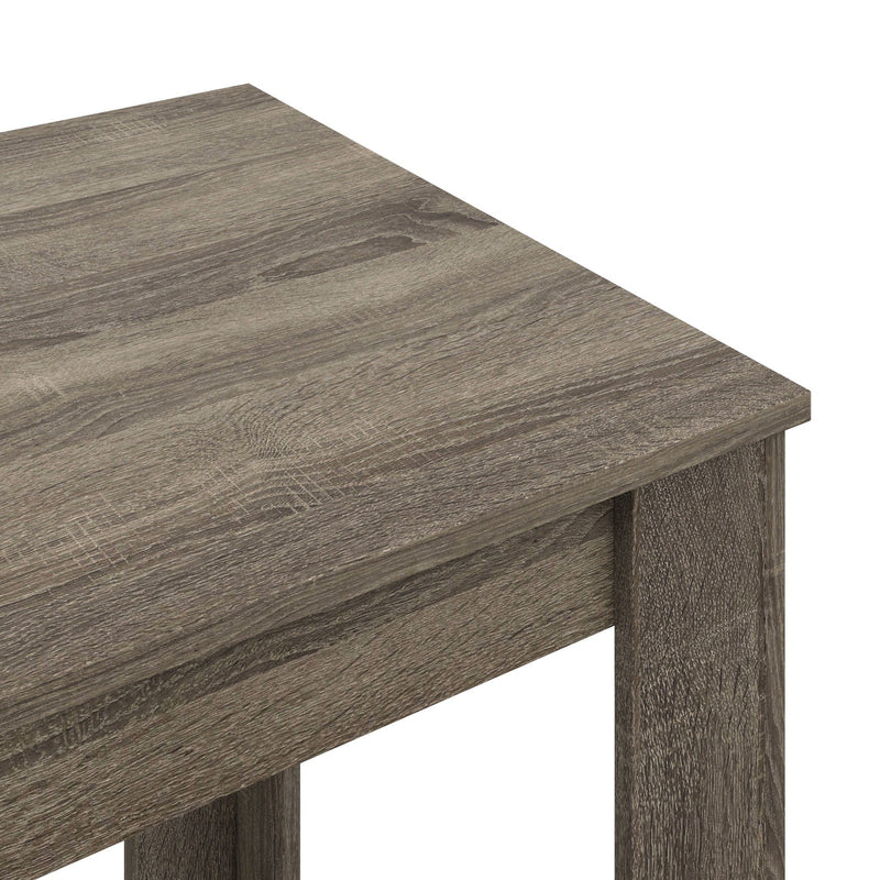 Close-up of the table corner showing the grey wood grain