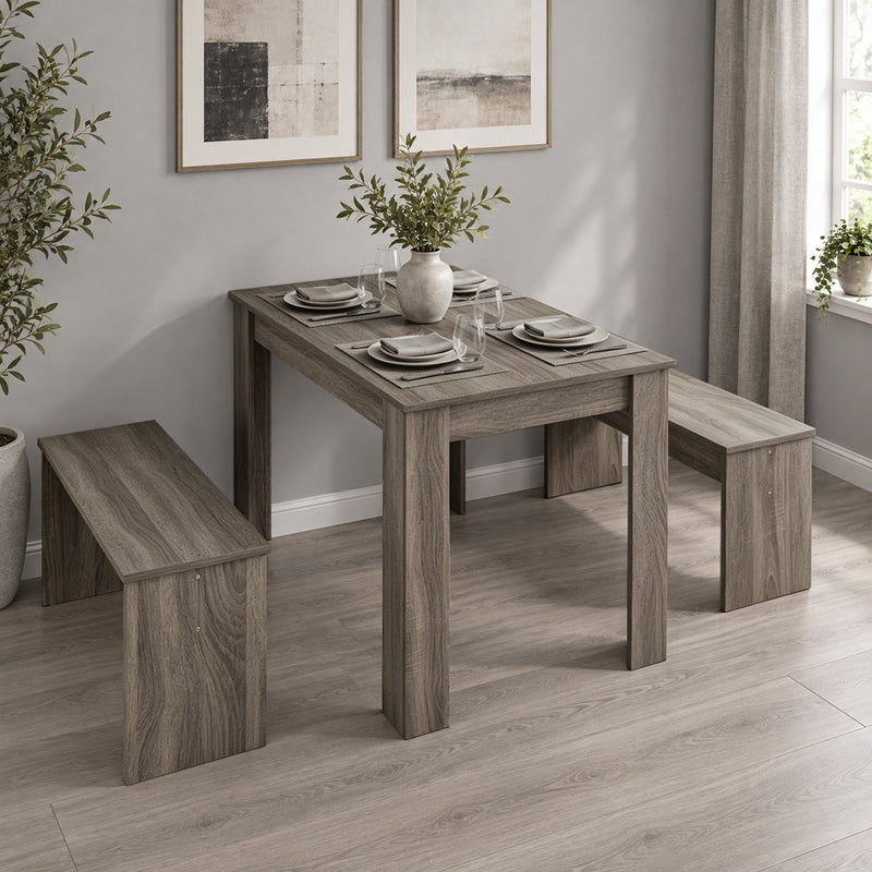 Dining set with place settings and a vase in a room with framed art