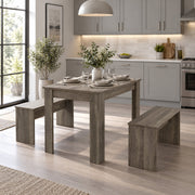 Dining set in a kitchen with grey cabinets and a large window