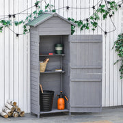 Wooden garden shed open on a patio under string lights with a sprayer inside