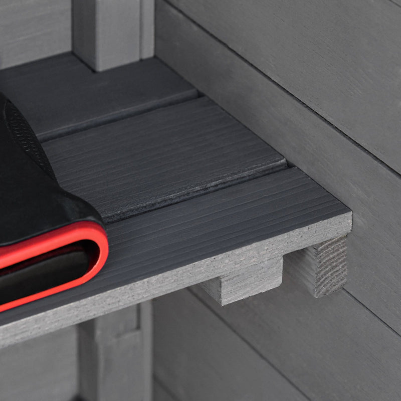 Detail of a shelf board and its timber cleat inside the dark grey wooden shed
