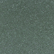 Close-up of the green asphalt granules covering the shed roof