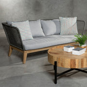 Grey woven rope sofa styled in a living room setting