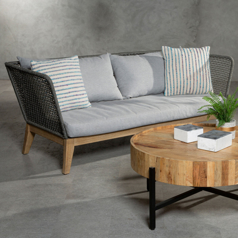 Grey woven rope sofa styled in a living room setting