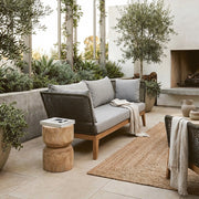 Grey woven rope sofa shown in an outdoor patio setting