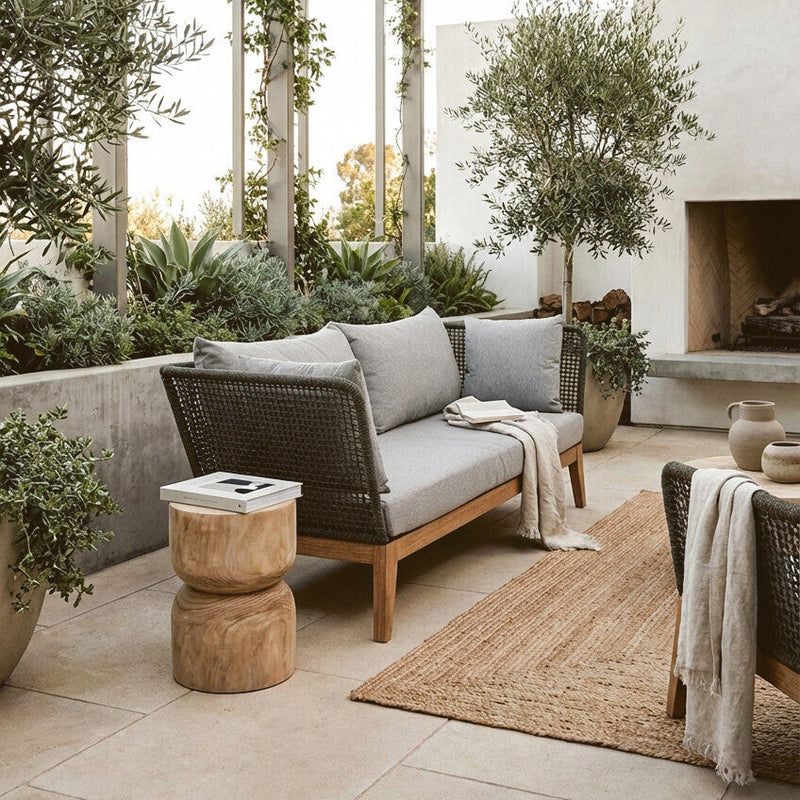 Grey woven rope sofa shown in an outdoor patio setting