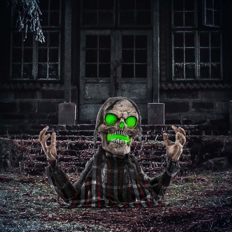 Homcom groundbreaker skeleton animatronic lit up at night outside a spooky house lifestyle scene