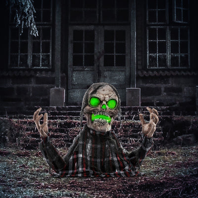 Homcom groundbreaker skeleton animatronic lit up at night outside a spooky house lifestyle scene