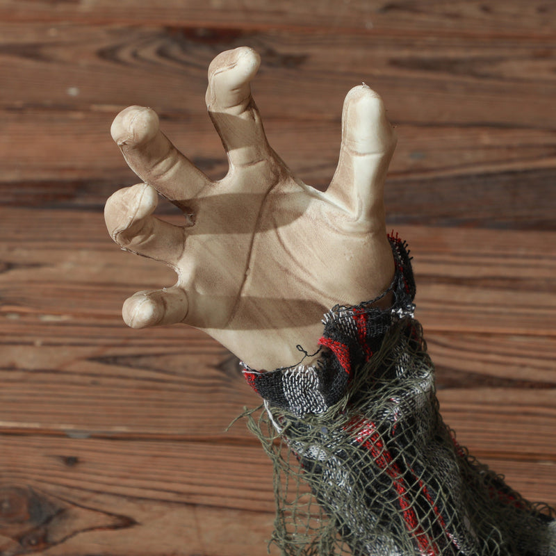 Close-up of the reaching hand and plaid sleeve on the Homcom groundbreaker skeleton