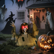 Half-body skeleton prop set up on a front lawn as part of a Halloween porch display