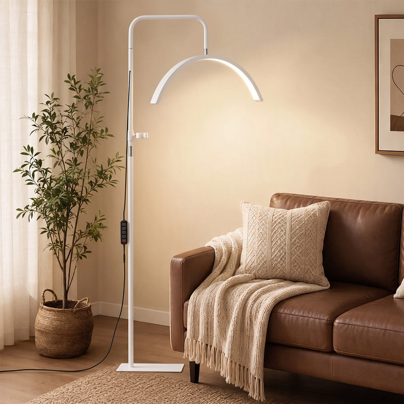 White half moon floor lamp beside a leather sofa in a living room