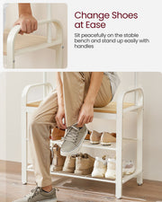 Person sitting on the shoe bench to put on trainers, with a hand on the side handle and shoes on the shelves below