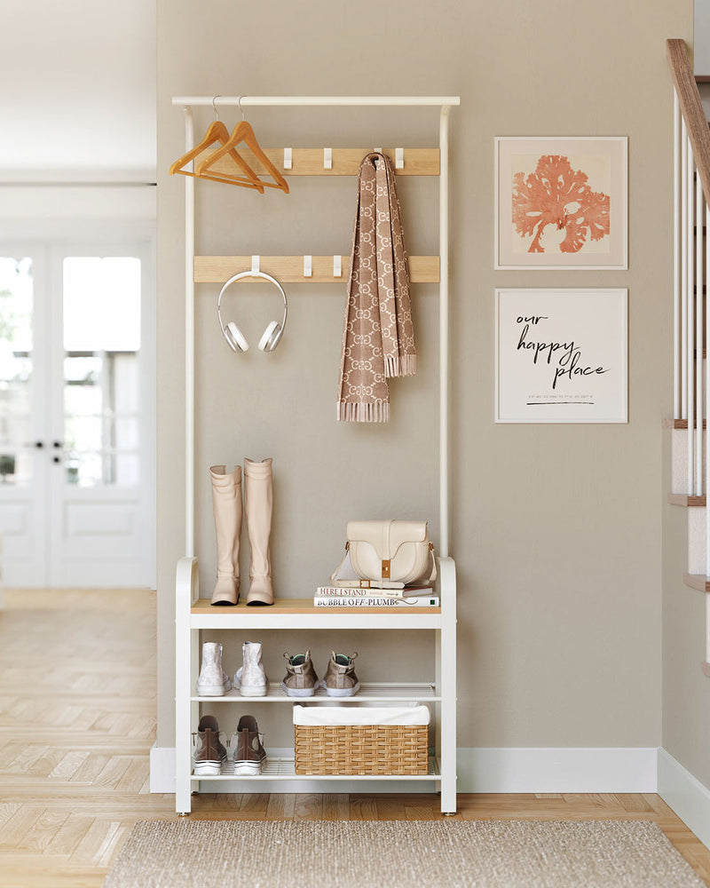 Hall tree against a hallway wall holding a scarf, headphones, boots, a handbag, shoes and a woven basket