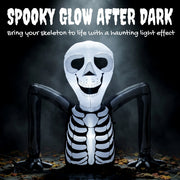 Ground crawling skeleton inflatable glowing white against a dark background