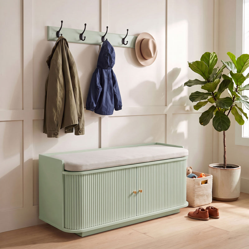 Light green hallway set styled with an olive jacket, navy raincoat and sun hat on the hooks