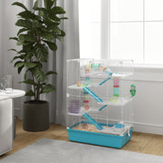 Light blue hamster cage styled in a living room beside a window and houseplant