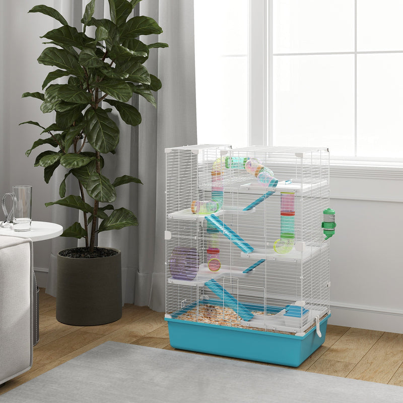 Light blue hamster cage styled in a living room beside a window and houseplant