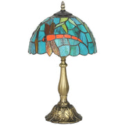 Stained glass table lamp with a dragonfly pattern shade, studio shot