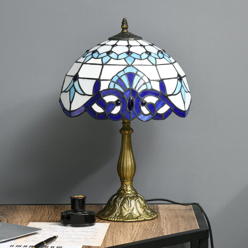 Table lamp on a writing desk beside an ink pot and sheet music
