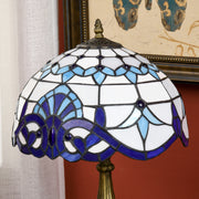 Close-up of the stained glass shade showing the scroll pattern and glass jewels