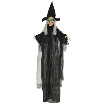 Hanging Halloween witch decoration in a black robe with green light-up eyes on a white background