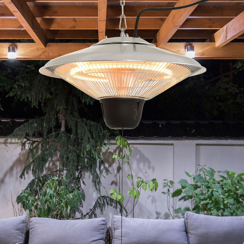 Hanging halogen heater suspended on a chain from wooden pergola beams above outdoor seating at dusk