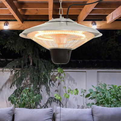 Hanging halogen heater suspended on a chain from wooden pergola beams above outdoor seating at dusk