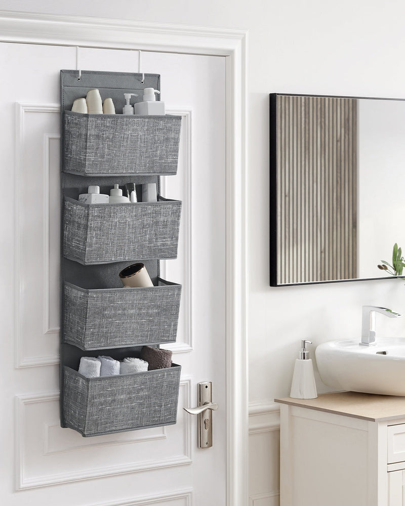 Hanging organiser on a bathroom door holding toiletries and towels