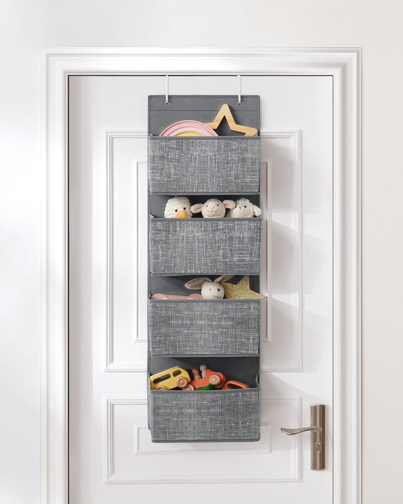 Hanging organiser on a kids bedroom door holding toys