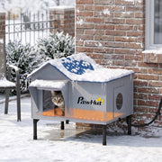 Cat house shown outdoors in snow with heating pad glowing warm underneath