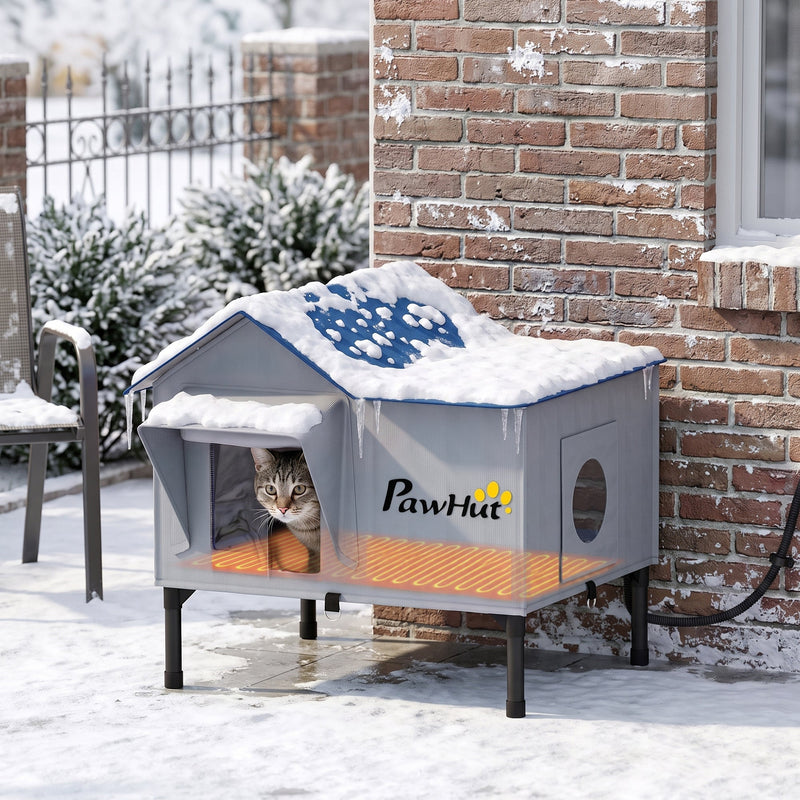 Cat house shown outdoors in snow with heating pad glowing warm underneath