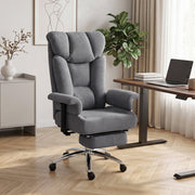 Grey office chair with footrest beside a wooden desk in a bright home office
